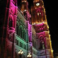 city hall is lit with colors at night